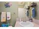 Bathroom featuring a vanity with sink, decorative fish art and open wall storage at 37338 Sandra Ave, Zephyrhills, FL 33542