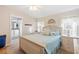 Comfortable bedroom featuring a ceiling fan, and light-toned furnishings adjacent to the bathroom at 37338 Sandra Ave, Zephyrhills, FL 33542
