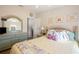 Bedroom with vibrant floral decor, bright sunlight, and unique green-toned furniture at 37338 Sandra Ave, Zephyrhills, FL 33542