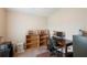 Bedroom with an organized workspace, featuring open shelving and dark-wood desk at 37338 Sandra Ave, Zephyrhills, FL 33542