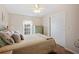 Bedroom with a window, closet, light walls, and floral pillows and bedding at 37338 Sandra Ave, Zephyrhills, FL 33542