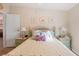 Bedroom with bright sunlight, floral decor, and light green furniture at 37338 Sandra Ave, Zephyrhills, FL 33542