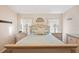 Well-lit bedroom with light-toned decor, matching nightstands, and a comfortable bed at 37338 Sandra Ave, Zephyrhills, FL 33542