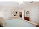 Cozy bedroom showcasing light-toned furnishings, a doorway to another room, and a decorative wreath at 37338 Sandra Ave, Zephyrhills, FL 33542