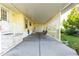 Spacious covered carport with a lattice partition, offering ample parking and outdoor storage, with lush landscaping at 37338 Sandra Ave, Zephyrhills, FL 33542