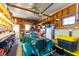 Well-lit garage and workshop area, featuring storage shelves and a classic car at 37338 Sandra Ave, Zephyrhills, FL 33542