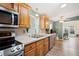 Bright kitchen with stainless steel appliances, oak cabinets, white countertops, and a view into the adjoining living space at 37338 Sandra Ave, Zephyrhills, FL 33542