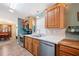 Cozy kitchen features wooden cabinets, stainless steel appliances, updated countertops, and seamless flow into the dining area at 37338 Sandra Ave, Zephyrhills, FL 33542