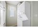 Bright laundry room featuring stacked washer and dryer and lots of cabinet space at 37338 Sandra Ave, Zephyrhills, FL 33542