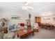 Comfortable living room with floral sofa, rocking chair, and open access to dining area at 37338 Sandra Ave, Zephyrhills, FL 33542