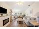 Bright living room with modern furniture, fireplace, and wood-look floors at 37338 Sandra Ave, Zephyrhills, FL 33542