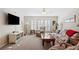 Relaxing living room with plantation shutters, comfortable seating, and a TV at 37338 Sandra Ave, Zephyrhills, FL 33542
