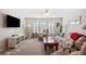 Comfortable living room with plantation shutters, TV, and plenty of seating at 37338 Sandra Ave, Zephyrhills, FL 33542