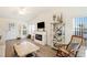 Bright living room featuring a fireplace, open shelving, and ample natural light at 37338 Sandra Ave, Zephyrhills, FL 33542
