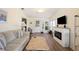 Bright living space featuring a fireplace, wood-look floors, and an open layout at 37338 Sandra Ave, Zephyrhills, FL 33542