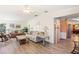 Open-concept living room with a cozy seating area, light wood floors, and natural light at 37338 Sandra Ave, Zephyrhills, FL 33542