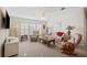 Cozy living room with comfortable seating, carpet flooring, and natural light at 37338 Sandra Ave, Zephyrhills, FL 33542