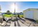 Backyard with a shed and patio, complete with an outdoor table and chairs at 37338 Sandra Ave, Zephyrhills, FL 33542