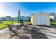 Outdoor patio features seating and a grill, adjacent to a shed with a double door entrance at 37338 Sandra Ave, Zephyrhills, FL 33542