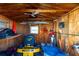 Shed interior with plywood walls and ceiling featuring a ceiling fan and lawn equipment at 37338 Sandra Ave, Zephyrhills, FL 33542