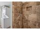 Shower featuring neutral-toned tile and a view to the laundry area at 37338 Sandra Ave, Zephyrhills, FL 33542