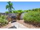 Backyard area featuring a grill, mature shrubs, and a brick pathway, perfect for summer cookouts at 3749 Mckay Creek Dr, Largo, FL 33770