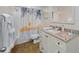 Bathroom with tiled shower, white vanity with granite countertop, and decorative mirror at 3749 Mckay Creek Dr, Largo, FL 33770