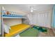 Bright bedroom features bunk beds, tropical rug and ample closet space at 3749 Mckay Creek Dr, Largo, FL 33770