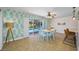 Dining area with tropical wallpaper and view of the pool through sliding glass doors at 3749 Mckay Creek Dr, Largo, FL 33770