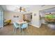Bright dining area with a view to the kitchen and an outdoor pool beyond sliding glass doors at 3749 Mckay Creek Dr, Largo, FL 33770