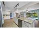 Kitchen with stainless steel appliances, granite countertops, and a seamless view to the outdoor pool area at 3749 Mckay Creek Dr, Largo, FL 33770