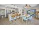 Bright kitchen with stainless steel appliances, island seating, and adjacent dining area at 3749 Mckay Creek Dr, Largo, FL 33770