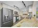 Bright kitchen with stainless steel refrigerator and appliances, tile backsplash, and granite countertops at 3749 Mckay Creek Dr, Largo, FL 33770