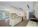 Well-lit kitchen with white cabinets, granite countertops, tile backsplash, and an open view to the pool at 3749 Mckay Creek Dr, Largo, FL 33770