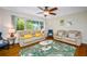 Bright living room featuring hardwood floors, comfortable seating, and large windows offering plenty of natural light at 3749 Mckay Creek Dr, Largo, FL 33770