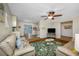 Bright living room featuring a tropical rug, leather couches, and an open view to the kitchen at 3749 Mckay Creek Dr, Largo, FL 33770