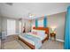 Spacious main bedroom with neutral tones, plush carpet, and bright blue curtains for a relaxing retreat at 3749 Mckay Creek Dr, Largo, FL 33770