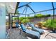 Relaxing patio area features lounge chairs, a grill, and privacy from landscaping; ideal for backyard entertainment at 3749 Mckay Creek Dr, Largo, FL 33770