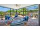Enclosed patio with comfortable seating, ceiling fan, and views of the backyard at 3749 Mckay Creek Dr, Largo, FL 33770