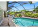 An inviting screened pool features convenient steps, lush landscaping, and is great for entertaining at 3749 Mckay Creek Dr, Largo, FL 33770