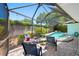 Enclosed patio with pool, seating, ceiling fan, and views of the yard at 3749 Mckay Creek Dr, Largo, FL 33770