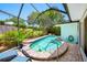 Inviting screened pool area features lush landscaping and brick-paved patio, perfect for outdoor relaxation and entertaining at 3749 Mckay Creek Dr, Largo, FL 33770
