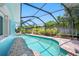 Relaxing screened pool with clear water, and landscaped surroundings, ideal for enjoying leisure time at 3749 Mckay Creek Dr, Largo, FL 33770