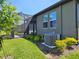 Beautiful backyard with a screened-in lanai, lush landscaping, and an air conditioning unit at 3776 Maxwell Park Dr, Sun City Center, FL 33573