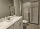 Bright bathroom with marble counters, vanity, faucet, toilet, and glass shower door at 3776 Maxwell Park Dr, Sun City Center, FL 33573