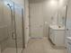 Bathroom with glass shower, white cabinets, and modern fixtures at 3776 Maxwell Park Dr, Sun City Center, FL 33573