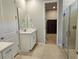 Bright bathroom with a glass-enclosed shower and tile floors leading to the walk-in closet at 3776 Maxwell Park Dr, Sun City Center, FL 33573