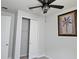 Bedroom featuring carpet, neutral walls, a ceiling fan with light, framed art, and closet at 3776 Maxwell Park Dr, Sun City Center, FL 33573
