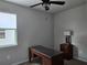 Bedroom featuring a ceiling fan, a window providing natural light, and an office desk at 3776 Maxwell Park Dr, Sun City Center, FL 33573
