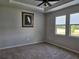 Comfortable bedroom with tray ceiling, ceiling fan, carpet and peaceful view at 3776 Maxwell Park Dr, Sun City Center, FL 33573